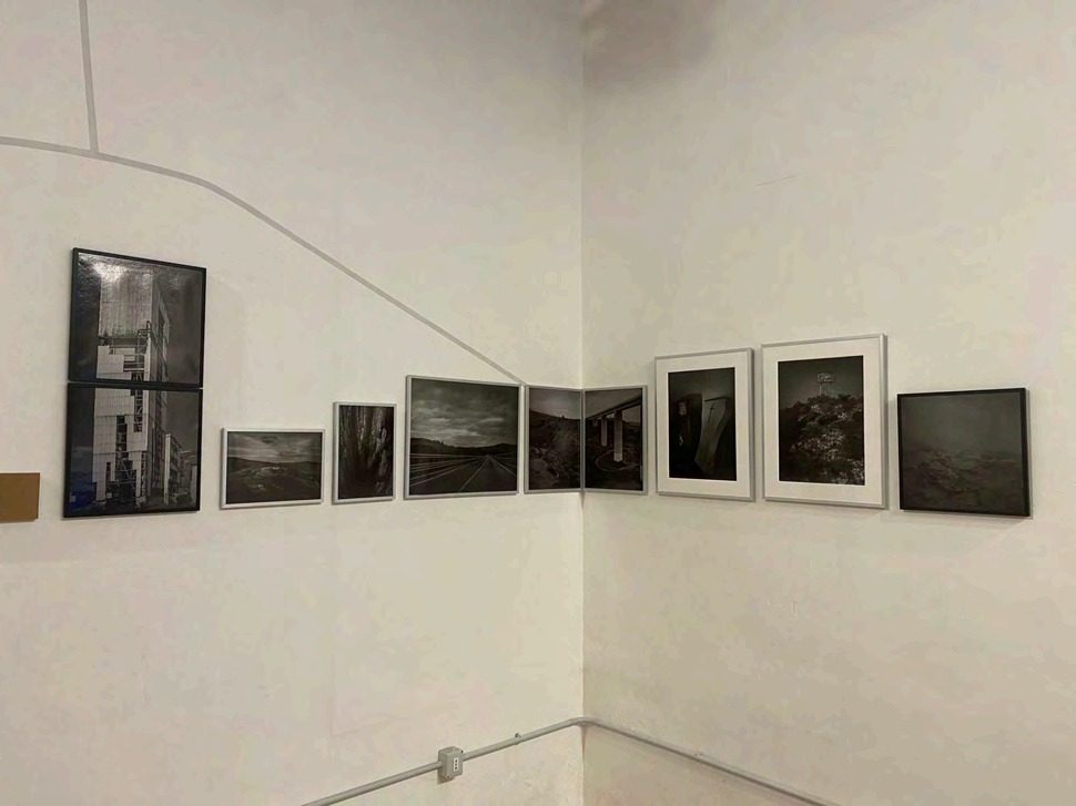 Framed photographs hanging in the 2LAB gallery