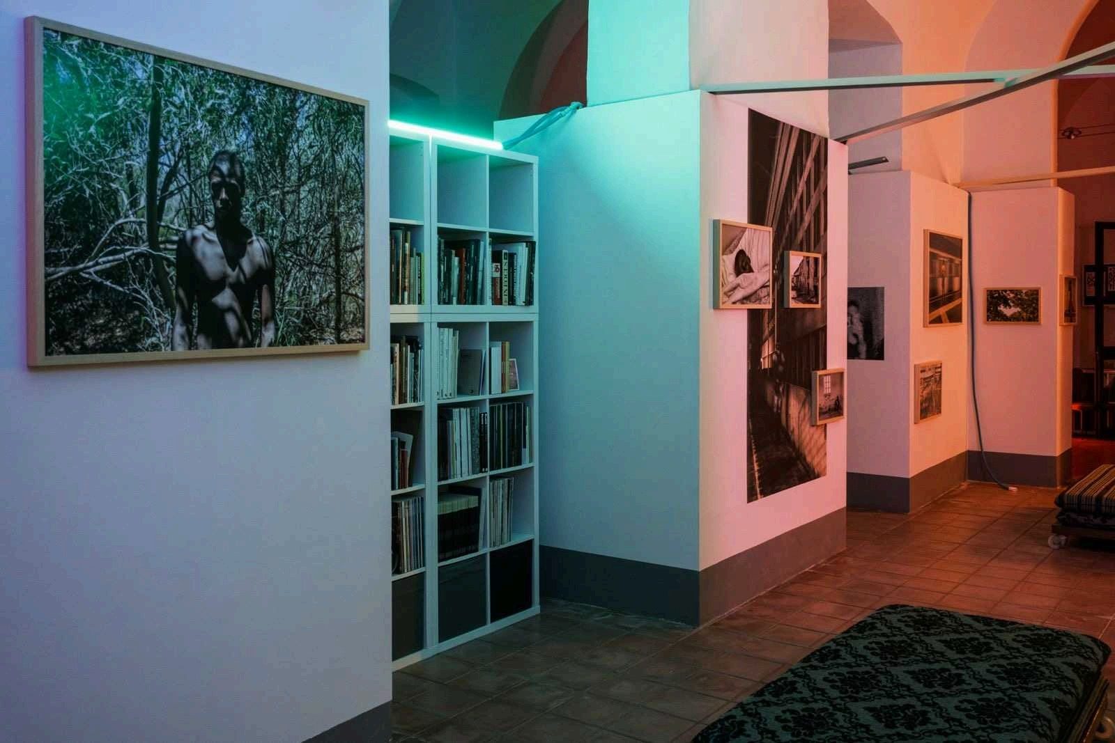 Interior of the 2LAB gallery with exhibition prints and bookshelves